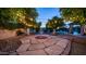 Charming backyard with stone patio, fountain, and string lights creates a magical outdoor setting for evening relaxation at 1532 N Ogden --, Mesa, AZ 85205
