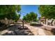 Picturesque backyard with a charming water fountain, mature trees, and stone pathway for a tranquil setting at 1532 N Ogden --, Mesa, AZ 85205
