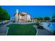 Expansive backyard boasts a well-maintained lawn, cozy patio, mature trees, and a refreshing pool, offering endless outdoor enjoyment at 1532 N Ogden --, Mesa, AZ 85205