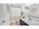 Modern bathroom with a single sink vanity, decorative mirror and tiled floors at 1532 N Ogden --, Mesa, AZ 85205