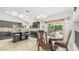 The kitchen and dining area feature black cabinets, an island with seating, and views to the backyard at 1532 N Ogden --, Mesa, AZ 85205