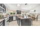 Modern kitchen with an island, stainless steel appliances, dark cabinets, and a breakfast nook at 1532 N Ogden --, Mesa, AZ 85205
