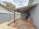 Backyard showcasing a covered patio area, privacy walls, storage shed, brick accents and gravel ground at 1553 E Flower Cir, Mesa, AZ 85204