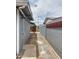 The backyard features a narrow pathway between the house and a grey brick wall at 1553 E Flower Cir, Mesa, AZ 85204