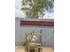 Backyard pool filter system with privacy wall and mature landscaping, enhancing the property's appeal at 1553 E Flower Cir, Mesa, AZ 85204