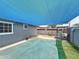 Backyard featuring shade sail, patio with dining set and privacy walls for a private outdoor space at 1553 E Flower Cir, Mesa, AZ 85204