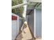 Narrow backyard pathway between a grey wall and the home's exterior at 1553 E Flower Cir, Mesa, AZ 85204