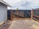 New dark wooden gate in gravel backyard offers privacy at 1553 E Flower Cir, Mesa, AZ 85204