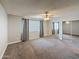 Bright bedroom featuring plush carpet, ceiling fan, a window with curtains, and mirrored closet doors at 1553 E Flower Cir, Mesa, AZ 85204