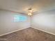Bedroom featuring plush carpet, ceiling fan, and natural lighting at 1553 E Flower Cir, Mesa, AZ 85204