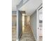Hallway showcasing the home's layout, connecting kitchen, bedrooms, and living spaces with modern flooring at 1553 E Flower Cir, Mesa, AZ 85204