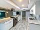 Gorgeous kitchen featuring white cabinets, granite countertops, and stainless steel appliances with a large island at 1553 E Flower Cir, Mesa, AZ 85204