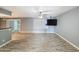 Open living room showcasing modern wood-style flooring, updated ceiling fan, and ample natural light at 1553 E Flower Cir, Mesa, AZ 85204