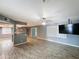 Spacious living area with modern flooring, ceiling fan, and view to the kitchen for open concept living at 1553 E Flower Cir, Mesa, AZ 85204