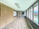 Enclosed patio boasting brick accents, tile floor, natural light, and access to the pool at 1553 E Flower Cir, Mesa, AZ 85204