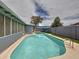 This inviting backyard pool area is surrounded by privacy walls, turf and access to a covered patio at 1553 E Flower Cir, Mesa, AZ 85204