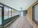 Bright sun room with clear pool views, tile floors, brick, and easy access to the outside at 1553 E Flower Cir, Mesa, AZ 85204