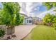 Well-maintained backyard featuring artificial turf, a patio, a built-in barbecue, and mature landscaping for year-round enjoyment at 1634 W Red Bird Rd, Phoenix, AZ 85085