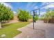 Inviting backyard has artificial turf, a basketball court, and ample space for recreation and relaxation at 1634 W Red Bird Rd, Phoenix, AZ 85085
