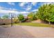 Spacious backyard features artificial turf, a basketball court, and a beautiful stone-paved patio, perfect for outdoor activities at 1634 W Red Bird Rd, Phoenix, AZ 85085