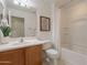 Bathroom featuring single vanity, shower-tub combination, and neutral accents at 1634 W Red Bird Rd, Phoenix, AZ 85085