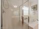 Bathroom boasts a glass shower enclosure and a luxurious soaking tub under a bright window at 1634 W Red Bird Rd, Phoenix, AZ 85085