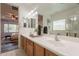 Bathroom showcases dual sinks, a large mirror, and an open view to the bedroom for an open feel at 1634 W Red Bird Rd, Phoenix, AZ 85085