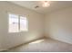 Bedroom with carpet flooring, window, and light fixture at 1634 W Red Bird Rd, Phoenix, AZ 85085
