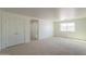 Bedroom featuring neutral carpet, natural light from window and access to another room at 1634 W Red Bird Rd, Phoenix, AZ 85085