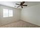 Bright bedroom with a ceiling fan and a window providing natural light at 1634 W Red Bird Rd, Phoenix, AZ 85085