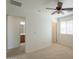 Bedroom with ceiling fan, natural light, and doorway access to bathroom and hallway at 1634 W Red Bird Rd, Phoenix, AZ 85085