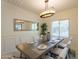 Dining area featuring a modern chandelier, a window with natural light, and views of the backyard at 1634 W Red Bird Rd, Phoenix, AZ 85085