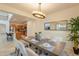 Dining area features a modern chandelier, seating for six, and a view of the kitchen and backyard at 1634 W Red Bird Rd, Phoenix, AZ 85085