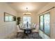Dining room featuring a large decorative mirror and sliding glass door for natural light at 1634 W Red Bird Rd, Phoenix, AZ 85085