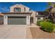 Charming two-story home featuring a two-car garage, desert landscaping, and a classic stucco facade at 1634 W Red Bird Rd, Phoenix, AZ 85085