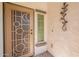 Close up of the front door with security screen and stylish decor elements at 1634 W Red Bird Rd, Phoenix, AZ 85085