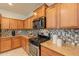 The kitchen has granite countertops, and a modern backsplash around stainless steel appliances at 1634 W Red Bird Rd, Phoenix, AZ 85085