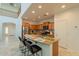 Eat-in kitchen features an island with seating, stainless steel appliances, and modern backsplash at 1634 W Red Bird Rd, Phoenix, AZ 85085