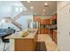 Bright kitchen with an island featuring granite countertops and stainless steel appliances, and a view of the staircase at 1634 W Red Bird Rd, Phoenix, AZ 85085