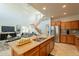 Bright kitchen featuring an island with granite countertops, stainless appliances, and a staircase in the background at 1634 W Red Bird Rd, Phoenix, AZ 85085