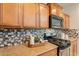 The kitchen has granite countertops and a modern backsplash around stainless steel appliances at 1634 W Red Bird Rd, Phoenix, AZ 85085