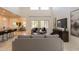 Open-concept living room features comfortable seating, entertainment center, and views of the adjacent dining area at 1634 W Red Bird Rd, Phoenix, AZ 85085