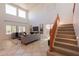 Spacious living room with high ceilings and a staircase, perfect for entertaining and relaxing at 1634 W Red Bird Rd, Phoenix, AZ 85085