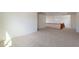 Open loft area with carpet flooring, and wood railing and staircase at 1634 W Red Bird Rd, Phoenix, AZ 85085