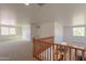 Spacious loft area overlooking the downstairs with wood railing and staircase at 1634 W Red Bird Rd, Phoenix, AZ 85085