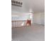 Bright loft area with neutral carpet, white walls, and a wooden banister overlooking the stairs at 1634 W Red Bird Rd, Phoenix, AZ 85085