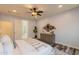 Comfortable main bedroom showing stylish decor, a bathroom doorway, and a modern ceiling fan at 1634 W Red Bird Rd, Phoenix, AZ 85085