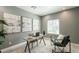 Well-appointed home office featuring a minimalist desk, comfortable seating, and serene artwork at 1634 W Red Bird Rd, Phoenix, AZ 85085