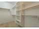 Bright walk-in closet with adjustable shelves and clothing rods for efficient storage and organization at 1634 W Red Bird Rd, Phoenix, AZ 85085
