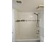 Bathroom featuring a shower over bath with white tiling and dark accent stripe at 1720 E Thunderbird Rd # 2087, Phoenix, AZ 85022